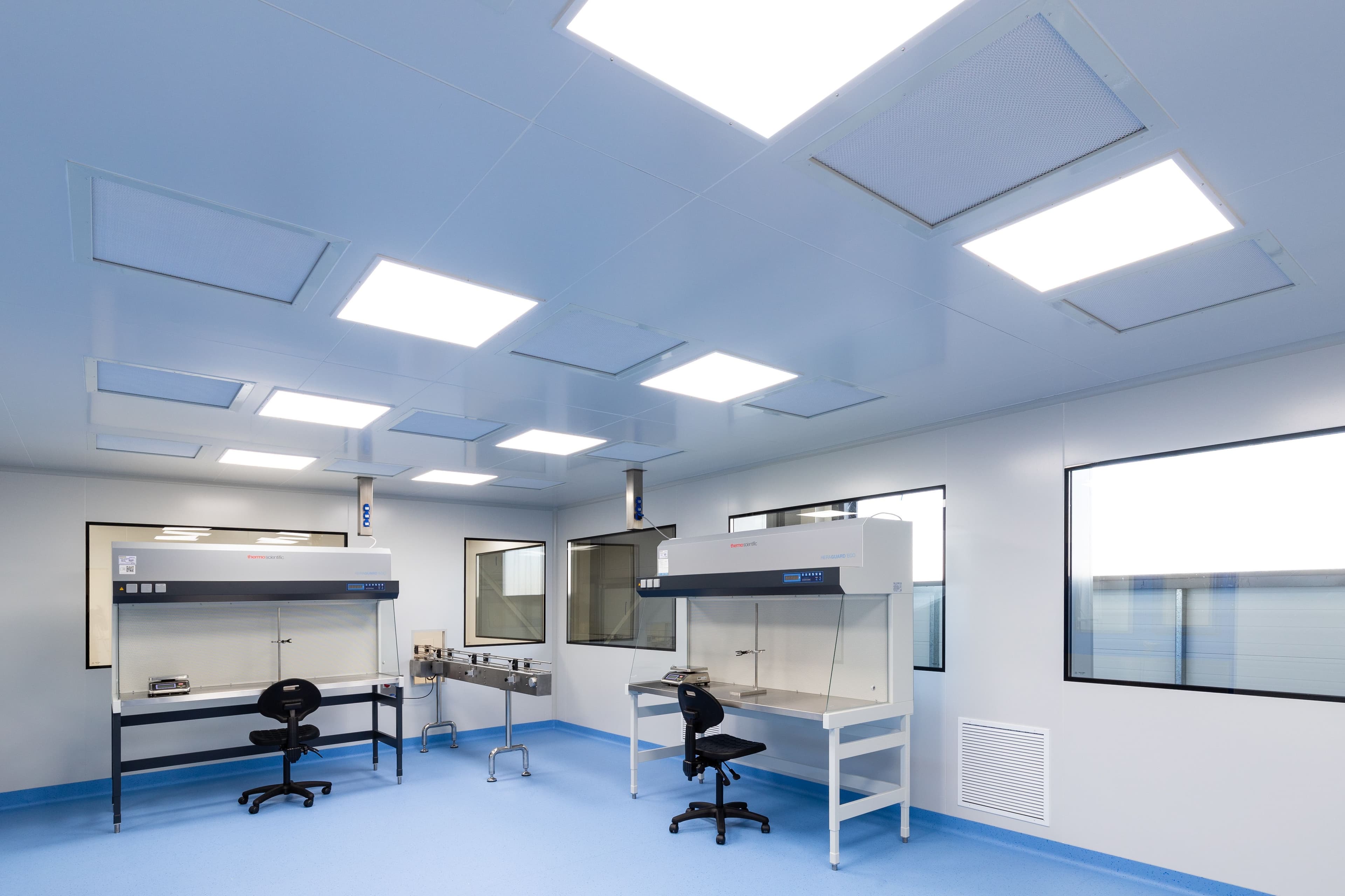 Modern pharmaceutical filling room with sterile equipment and white surfaces
